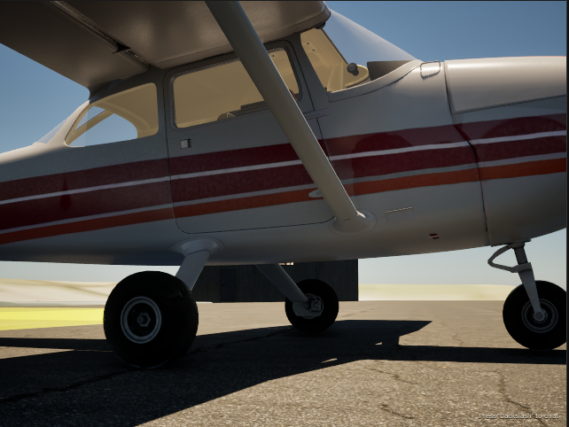 Close view of a red-and-white aircraft and its landing gear on the apron